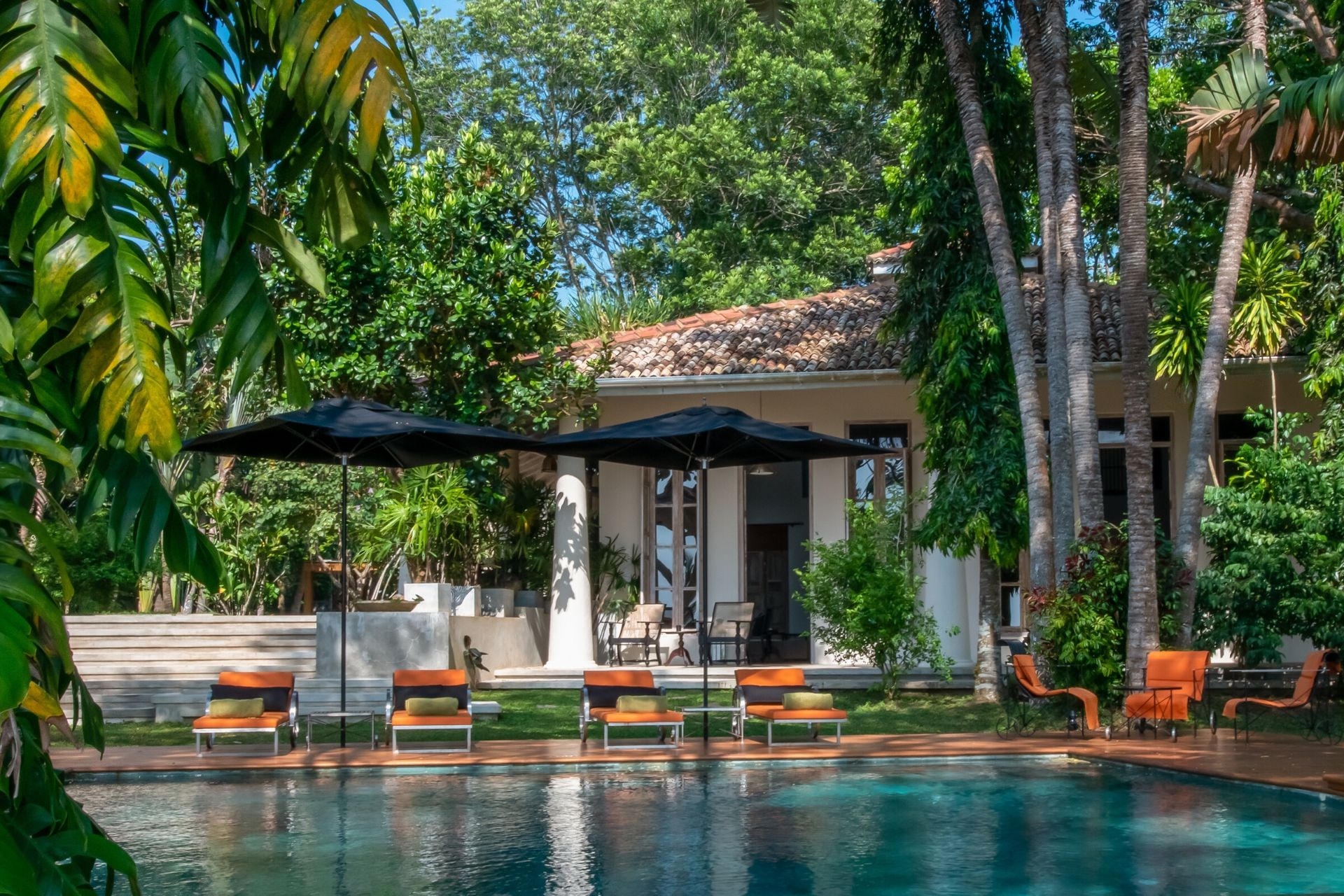 Outdoor lounge area of the colonial mansion overlooking the pool