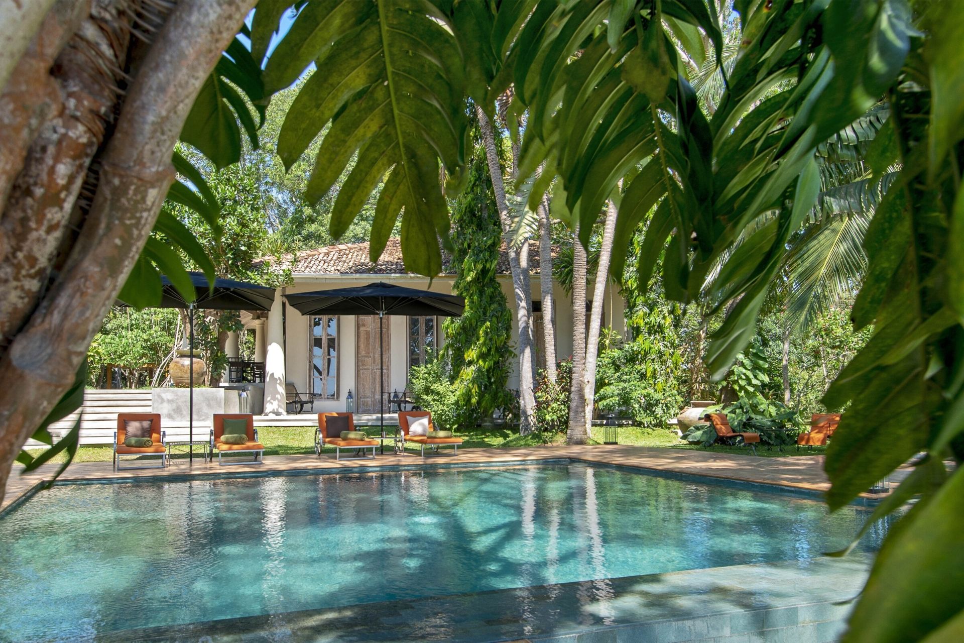 Outdoor lounge area of the colonial mansion overlooking the pool