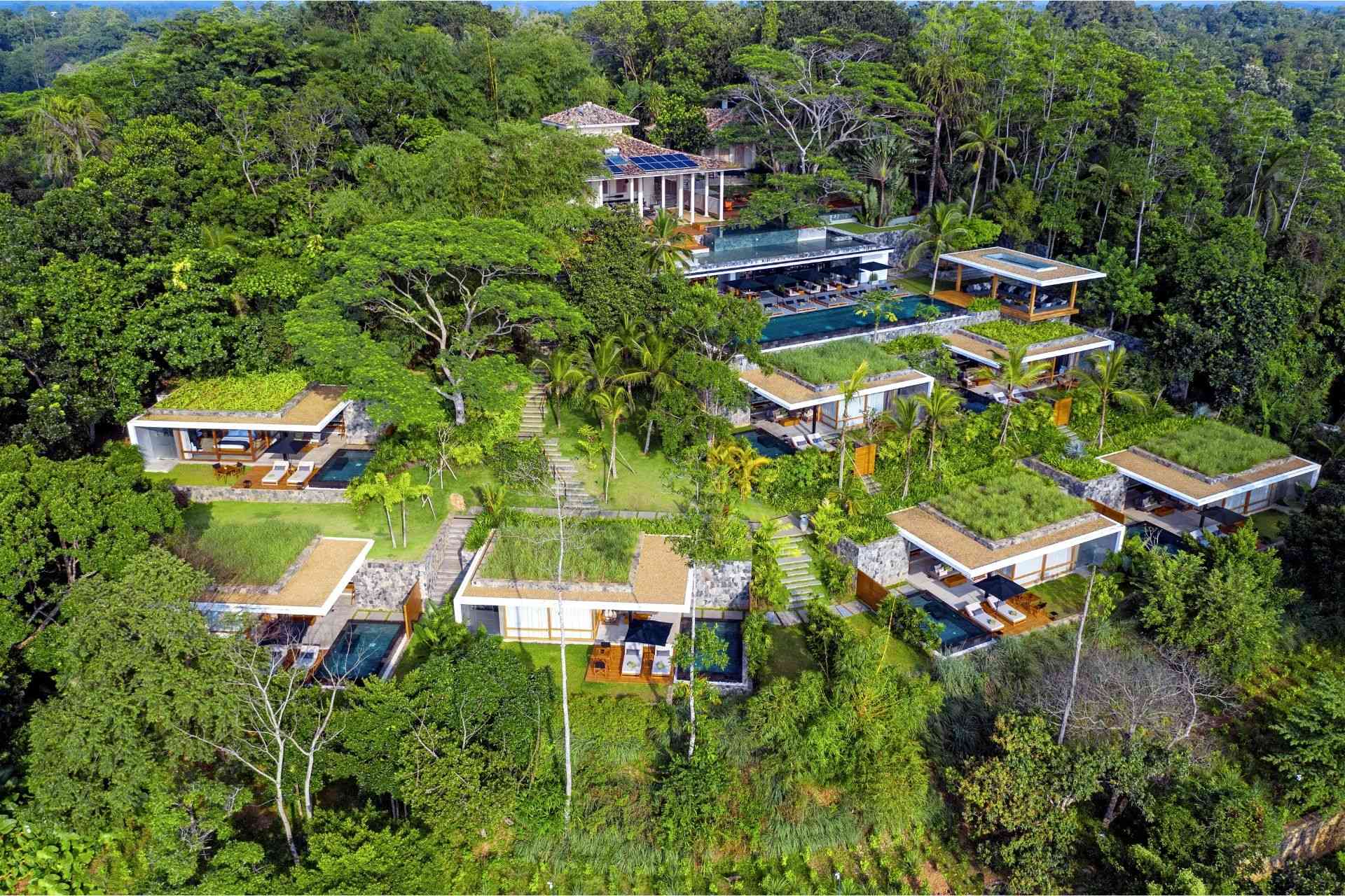Aerial view of the Haritha Villas and Spa property, overlooking the greenery, infinity pools, colonial villas & contemporary villas