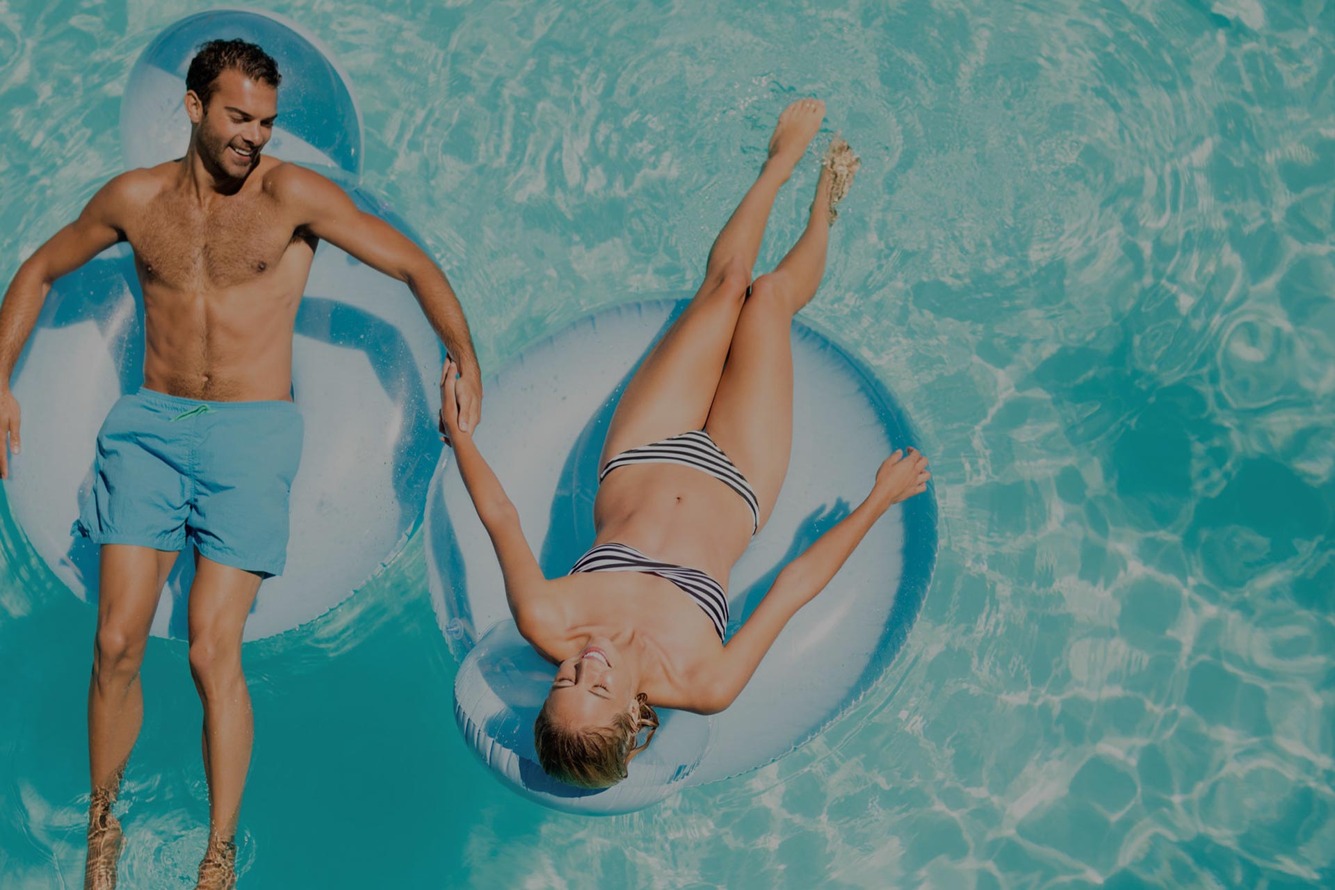 Couple on floaties relaxing in the Salt Water pool