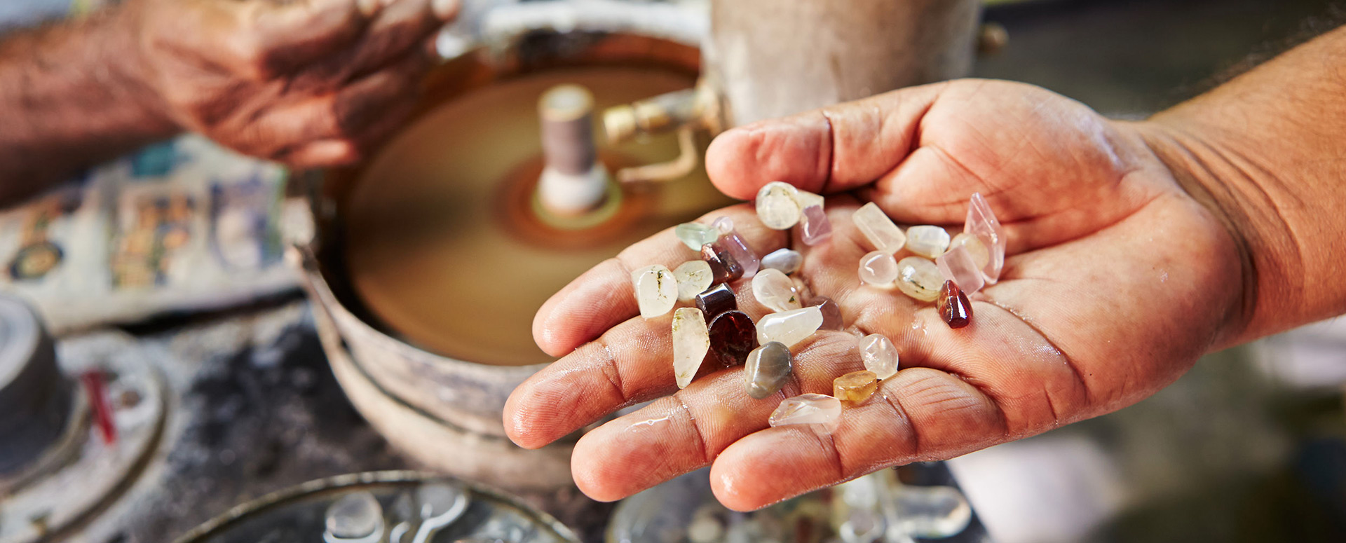 Uncut gem stones in the palms of a miner